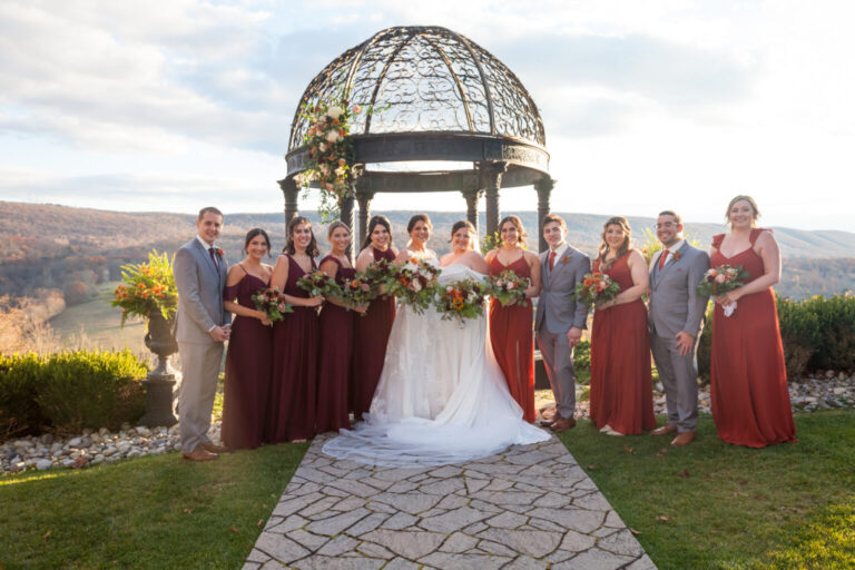 Brides with bridal party at ceremony site