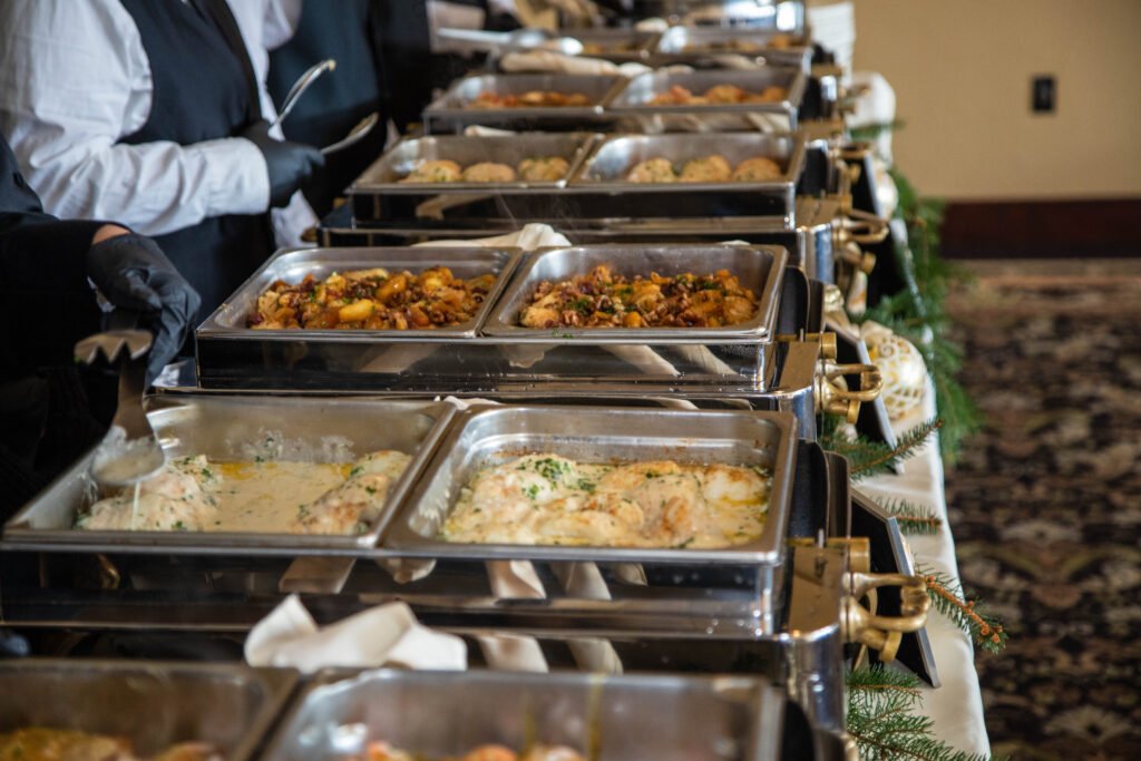 Buffet line featuring various entrées