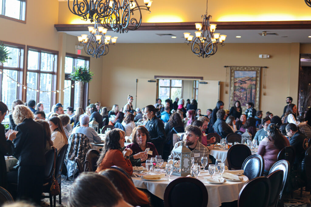 Event attendees sit down for their meal