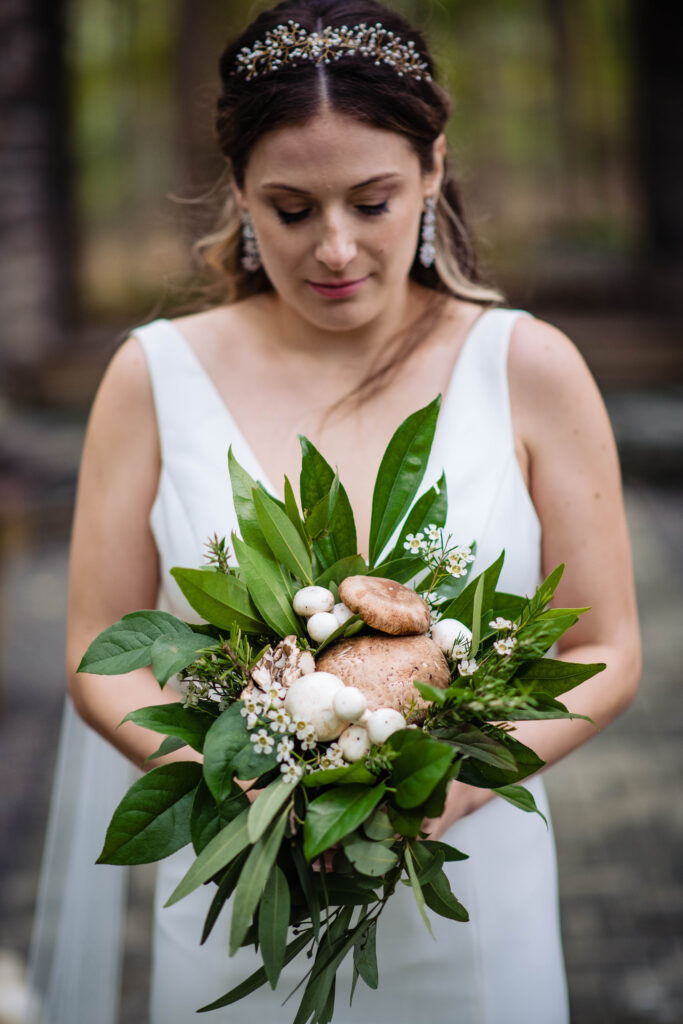 Bride holds bouquet featuring mushrooms