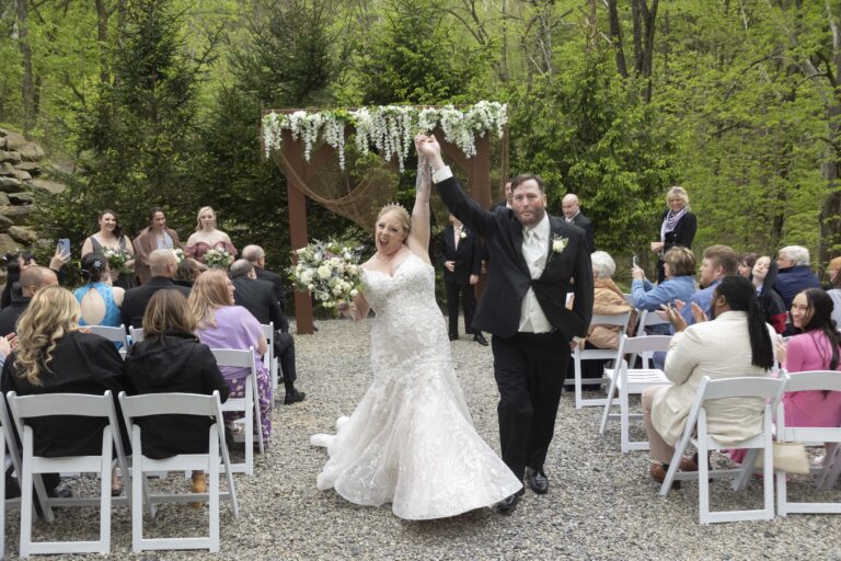 Bride and groom recess up ceremony aisle at SCI Pavilion